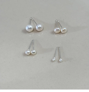 Detail showing four pairs of freshwater pearl stud earrings in varying size gradients