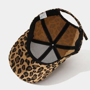 Detail of the leopard baseball cap interior showing 100% cotton label and reinforced seams