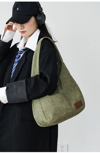 Detailed close-up showing the soft corduroy texture and green fabric of the shoulder bag