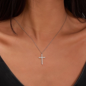 Macro shot of S925 sterling silver cross pendant necklace with sparkling inlaid zircons