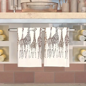 Detail of white microfiber kitchen towels with giraffe print hanging in a bathroom
