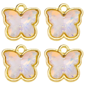 Close-up of four butterfly charms with gold metal frame and iridescent white crystals