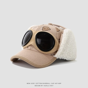 Detail of khaki corduroy kids pilot hat with white fleece earflaps and bear print
