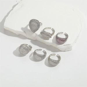 Detailed view of silver adjustable rings with diverse zircon heart and round shapes