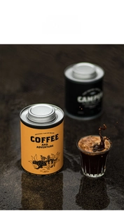 Detail of airtight tin coffee canisters featuring yellow leopard print and adventure design