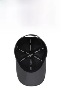 Detail view of dark grey baseball cap interior with brand taping and metal buckle