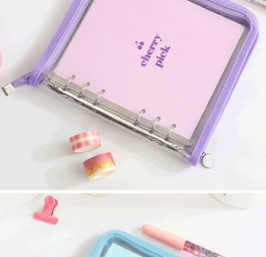 Detail of purple and blue PVC binder notebooks with zippers and cherry pattern inserts