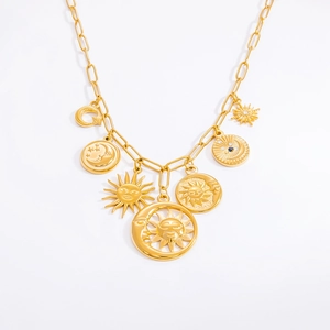 Detailed macro view of gold celestial sun moon star pendants on thick chain necklace