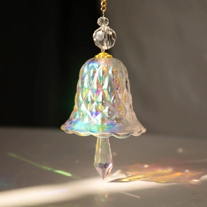 Detailed view of rainbow crystal bell suncatcher with diamond texture and light reflection