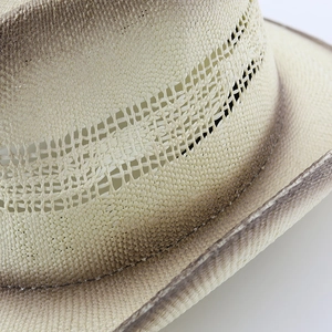 Detail of hand-woven straw hat showing hollow knit band and vintage gradient spray finish