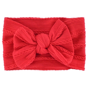 Red jacquard nylon baby headband with a soft large bow on a clean white background