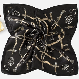 Detail of elegant black and gold silk square scarf with equestrian chain print pattern