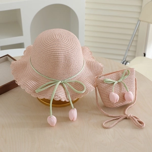 Pink straw hat and matching crossbody bag with tulip charms and green silk bows