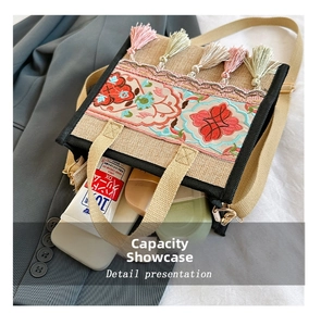 Detail presentation of floral embroidery and colorful tassels on an ethnic burlap tote bag