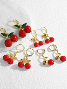 Detail of assorted cherry drop earrings with red enamel and gold plating finish