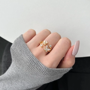 Detailed view of a gold S925 silver ring featuring butterfly and flower zircon inlay