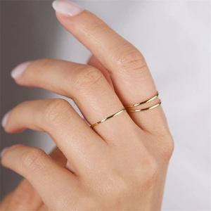 Minimalist gold plated stainless steel thin rings for women shown in a layered stack style