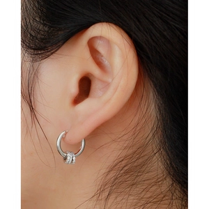 Close-up of S925 sterling silver hoop earrings with three pavé crystal beads on ear