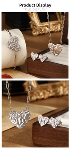 Detail of 925 silver heart jewelry set with unique crushed paper texture on the surface
