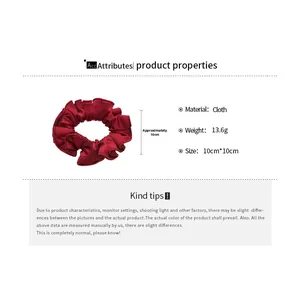 Detail showing red satin fabric scrunchie with elastic pleated texture and dimensions