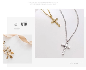Detailed view of gold and silver cross necklaces with shimmering pavé crystal settings