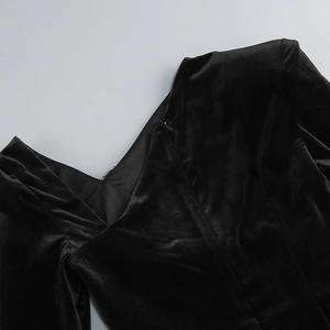 Close-up of neckline and zipper detail on black velvet bodycon dress with high-end sewing