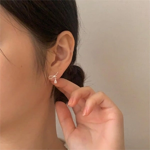 Detail of S925 silver bow stud earrings featuring a sparkling zircon water drop pendant