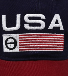Detailed macro shot of 3D USA embroidery and stitch texture on navy baseball cap