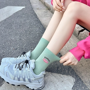 Women's light green mid-calf sports socks with vertical rib knit and small embroidery