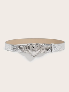 Detail of silver belt buckle with heart and wings on snakeskin texture leather