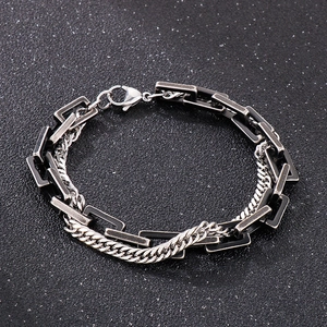 Detailed shot of double-layered Cuban chain bracelet with vintage link and lobster clasp