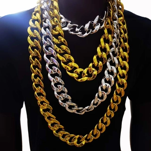 Layered gold and silver chunky Cuban link necklaces shown on a black mannequin bust