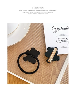 Cute black bear acetate hair clip and high elastic hair tie on a decorative glass tray