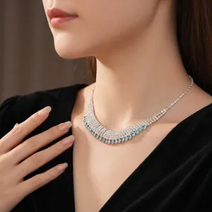 Elegant silver V-shaped fringe necklace with blue teardrop pendants and white zircons