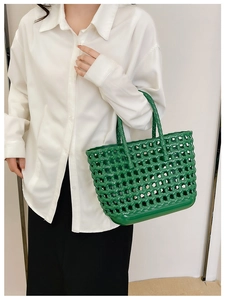 Close-up of green hollow-out woven basket bag paired with a minimalist summer casual outfit