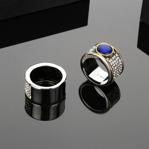 Macro d'une bague en titane argenté avec pierre bleue et pavage de diamants blancs