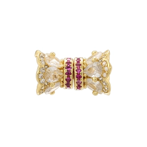 Macro shot of gold-plated barrel bead with pink and white cubic zirconia for jewelry DIY