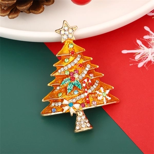 Enameled Christmas tree brooch with colorful rhinestones on a festive background