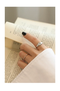 Detail of S925 sterling silver signet ring with star engraving and zircon open ring set