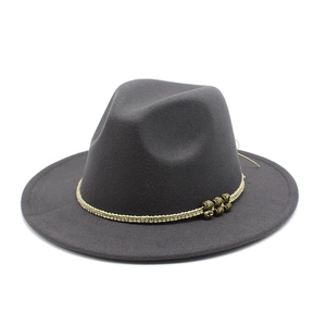 Detail of dark grey fedora hat with woven rope band and vintage gold patterned beads
