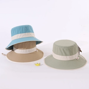 Close-up of three wide-brim kids sun hats in blue, khaki, and green with chin straps