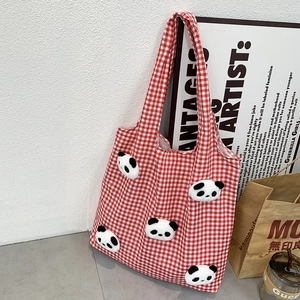 Detail of red and white checkered canvas tote bag with 3D plush panda decorations
