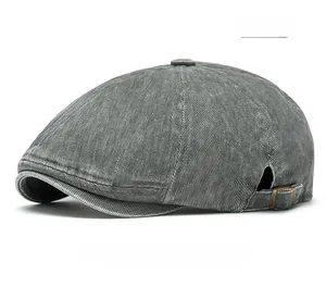 Detail view of washed grey newsboy cap showing twill texture and brass side buckle