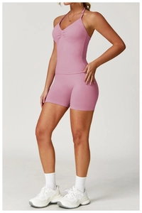 Professional full view of pink high waist seamless yoga shorts and matching crop top set