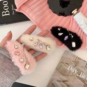 Elegant plush headband with rhinestones and metal charms in pink, beige, and black