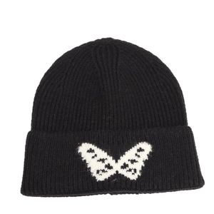 Black ribbed knit beanie featuring a white butterfly jacquard pattern and folded cuff