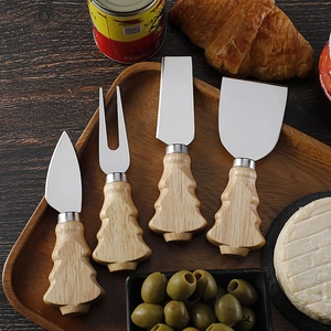 Detail of 4-piece stainless steel cheese knife set with Christmas tree wooden handles