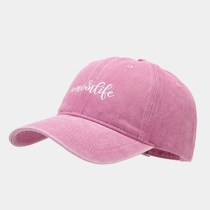 Detail of vintage pink washed cotton baseball cap with white #momlife embroidery