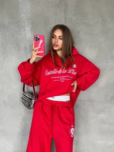 Detail view of the embroidered logo and graphic print on a red athletic sweatshirt