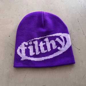 Detail of purple knitted beanie featuring jacquard filthy text and ribbed texture